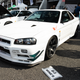 a white nissan gt-r with turquoise accents parked at r's meeting